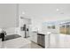 Modern kitchen with a center island, stainless steel appliances, and open layout to the living space at 16466 Bird Of Paradise Ave, Clermont, FL 34714