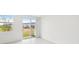Bright living room with a sliding glass door and large windows showcasing a view of the outdoors at 16466 Bird Of Paradise Ave, Clermont, FL 34714