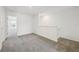 Spacious loft area with neutral carpet and bright natural light entering from the open doorway at 16466 Bird Of Paradise Ave, Clermont, FL 34714