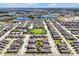 Expansive aerial view of a community with lakes, clubhouse, pool, playground, and well-maintained residences at 16527 Sea Glass St, Winter Garden, FL 34787