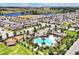 Community aerial view featuring a large swimming pool, playground, and meticulously landscaped surroundings at 16527 Sea Glass St, Winter Garden, FL 34787