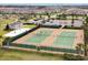 An aerial view showcasing tennis courts, a playground, and meticulously designed community spaces at 16527 Sea Glass St, Winter Garden, FL 34787
