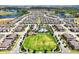 Beautiful aerial view of a neighborhood with a central green, pool, and playground at 16527 Sea Glass St, Winter Garden, FL 34787
