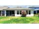 Cozy backyard featuring green grass and a beautiful flowering shrub at 16527 Sea Glass St, Winter Garden, FL 34787