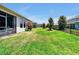 Lush backyard with green grass, black metal fence, and privacy landscaping at 16527 Sea Glass St, Winter Garden, FL 34787
