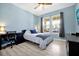 Bedroom featuring natural light, work desk, and laminate flooring at 16527 Sea Glass St, Winter Garden, FL 34787