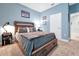 Bedroom with wooden bed frame with storage drawers, carpet flooring and neutral-colored walls at 16527 Sea Glass St, Winter Garden, FL 34787