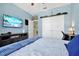 Bedroom with blue walls, laminate flooring, TV, and closet at 16527 Sea Glass St, Winter Garden, FL 34787