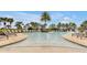 Resort-style community pool with shallow water areas, beach chairs, and palm trees for relaxation at 16527 Sea Glass St, Winter Garden, FL 34787