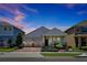 Charming single-story home featuring a well-manicured front yard, a two-car garage, and a welcoming covered entry at 16527 Sea Glass St, Winter Garden, FL 34787