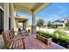 Welcoming covered porch with a wooden bench, brick flooring, and planter boxes offering a relaxing outdoor space at 16527 Sea Glass St, Winter Garden, FL 34787