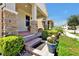Charming front porch with brick steps, stone pillars, potted flowers, and manicured greenery adds curb appeal to the home at 16527 Sea Glass St, Winter Garden, FL 34787