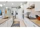 Contemporary kitchen featuring stainless steel appliances, white cabinetry, and ample counter space at 16527 Sea Glass St, Winter Garden, FL 34787