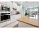 Well-equipped kitchen with stainless steel appliances, modern lighting, and an island with bar seating at 16527 Sea Glass St, Winter Garden, FL 34787