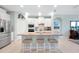 Modern kitchen with a large island, stainless steel appliances, and pendant lighting at 16527 Sea Glass St, Winter Garden, FL 34787