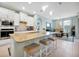 Bright, open kitchen with a large island, modern appliances, and a seamless flow to the dining area at 16527 Sea Glass St, Winter Garden, FL 34787