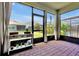 Screened lanai with brick pavers and views of the backyard and neighboring homes at 16527 Sea Glass St, Winter Garden, FL 34787