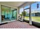 Relaxing screened lanai with brick pavers and outdoor seating, offering tranquil views of the backyard at 16527 Sea Glass St, Winter Garden, FL 34787