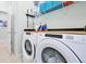 Laundry room with washer, dryer, storage shelves, and adjacent doorway at 16527 Sea Glass St, Winter Garden, FL 34787