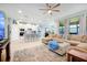 Open-concept living room flowing into a kitchen, with a large sectional sofa and ample seating at 16527 Sea Glass St, Winter Garden, FL 34787