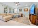 Spacious living room featuring a large sectional sofa, area rug, and large windows at 16527 Sea Glass St, Winter Garden, FL 34787
