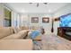Comfortable living room with a large sectional sofa, plush rug, and entertainment center at 16527 Sea Glass St, Winter Garden, FL 34787