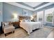 Comfortable bedroom with a king-size bed, side tables, and lots of natural light at 16527 Sea Glass St, Winter Garden, FL 34787