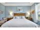 Bright main bedroom featuring a king bed, wood headboard and beautiful blue accent wall with floral artwork at 16527 Sea Glass St, Winter Garden, FL 34787