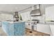 Outdoor kitchen boasting stainless steel appliances, a mosaic-tiled island, and functional design at 16527 Sea Glass St, Winter Garden, FL 34787