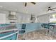 Community outdoor kitchen area featuring a tiled bar, stainless steel appliances, and ample seating at 16527 Sea Glass St, Winter Garden, FL 34787