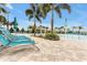 Lounge chairs and patio surrounding a community pool, offering an inviting space for relaxation and socialization at 16527 Sea Glass St, Winter Garden, FL 34787