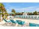 Resort-style pool and lounging area with ample seating, palm trees, and a water fountain feature at 16527 Sea Glass St, Winter Garden, FL 34787