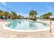 Spacious resort-style swimming pool area featuring clear water and numerous palm trees creating a tropical paradise at 16527 Sea Glass St, Winter Garden, FL 34787