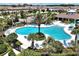 Aerial view of a community pool surrounded by palm trees and lounge chairs at 16527 Sea Glass St, Winter Garden, FL 34787