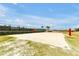 A pristine sand volleyball court surrounded by lush greenery, ideal for outdoor fun at 16527 Sea Glass St, Winter Garden, FL 34787