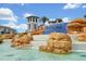 Beautiful community water feature and entrance in the community of Waterleigh with palm trees, blue tile and stone features at 16527 Sea Glass St, Winter Garden, FL 34787