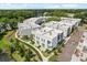 Aerial view of modern townhomes with a tranquil lake backdrop, highlighting community amenities at 1768 Mondrian Cir, Winter Park, FL 32789