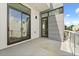A balcony with a gray floor and glass railing, offering natural light and an outdoor view at 1768 Mondrian Cir, Winter Park, FL 32789