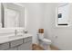 Modern bathroom featuring a gray vanity, sink, toilet and a window bringing in natural light at 1768 Mondrian Cir, Winter Park, FL 32789
