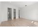 Minimalist bedroom with light hardwood floors and bathroom and closet entrances at 1768 Mondrian Cir, Winter Park, FL 32789