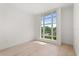 Bright bedroom with light hardwood floors and a large window view of lush green landscape at 1768 Mondrian Cir, Winter Park, FL 32789