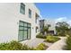 A modern home boasts large windows and doors surrounded by lush green landscaping at 1768 Mondrian Cir, Winter Park, FL 32789