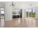 Bright living space with hardwood floors, kitchen, and large windows providing ample natural light at 1768 Mondrian Cir, Winter Park, FL 32789