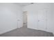 Bedroom with neutral color palette, plush carpeting, and white doors at 1801 Archer Dr, Minneola, FL 34715