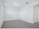 Empty bedroom featuring plush carpeting, ample natural light, and neutral color palette at 1801 Archer Dr, Minneola, FL 34715
