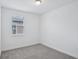 Bedroom featuring plush carpeting, ample natural light, and neutral color palette at 1801 Archer Dr, Minneola, FL 34715