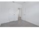 Bedroom with neutral color palette, plush carpeting, and white doors at 1801 Archer Dr, Minneola, FL 34715