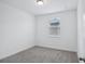 Bedroom featuring plush carpeting, ample natural light, and neutral color palette at 1801 Archer Dr, Minneola, FL 34715