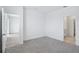 Comfortable bedroom with soft carpeting, two doorways, and white walls at 1801 Archer Dr, Minneola, FL 34715