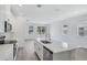Open concept kitchen featuring white cabinets, a center island, and an open layout at 1801 Archer Dr, Minneola, FL 34715
